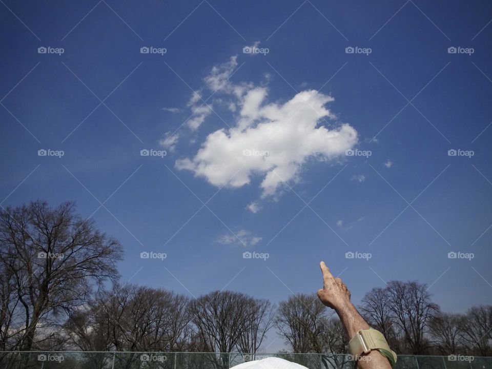 A man pointing the clouds 