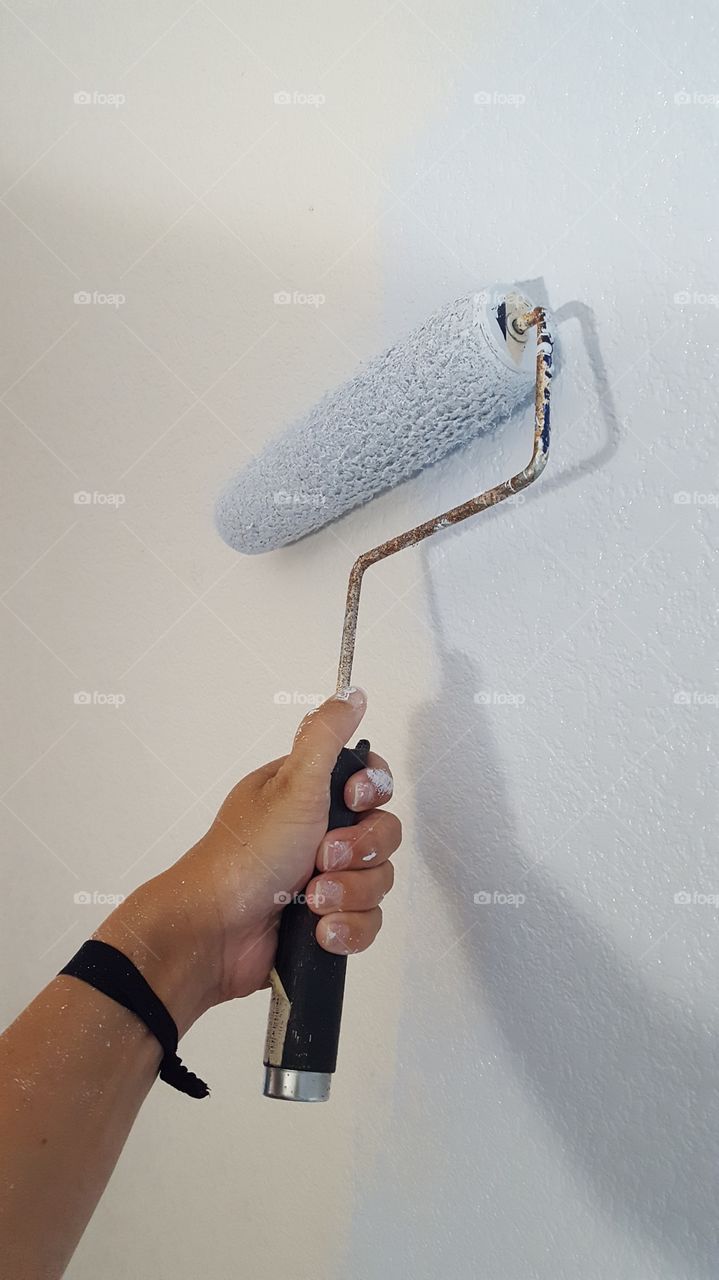 using a paint roller to paint