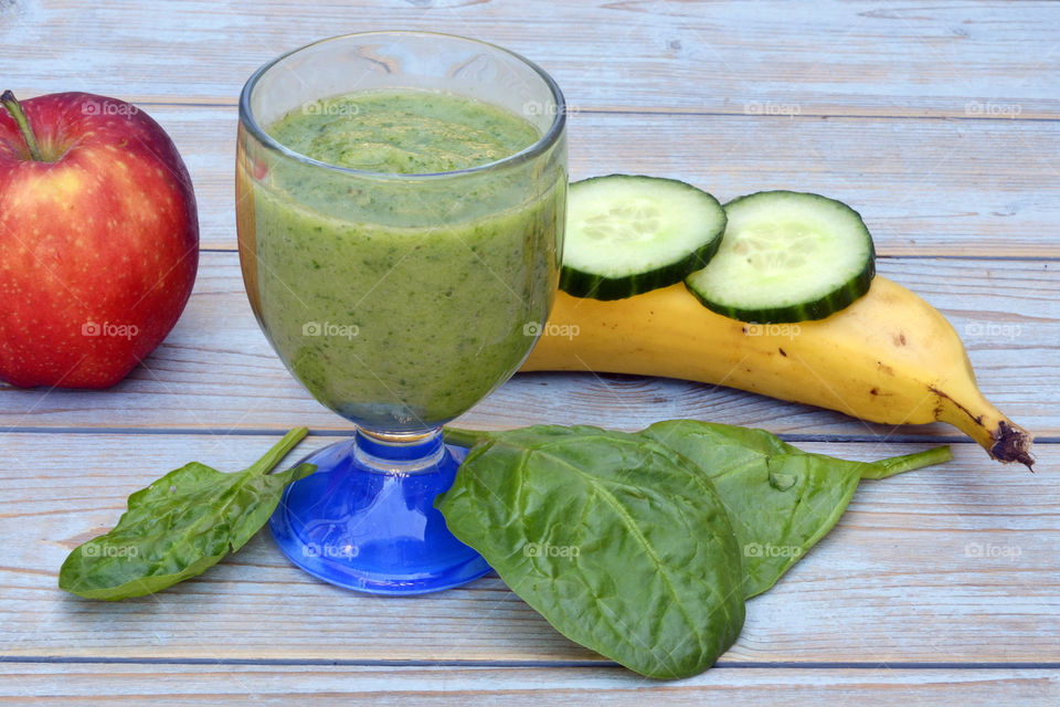 Green smoothie in a glass on a table