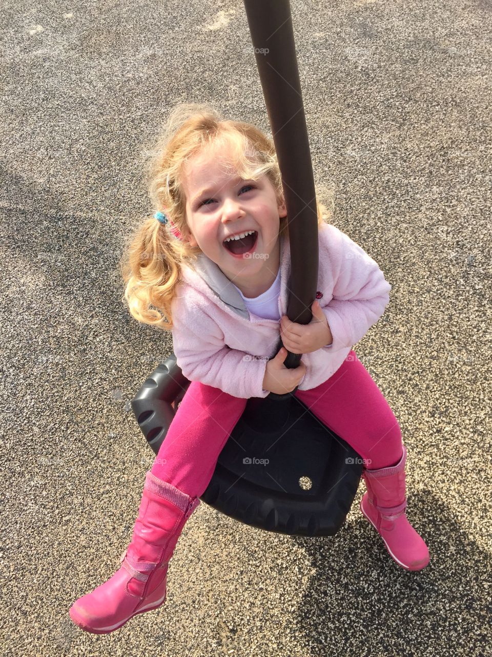 Cute girl playing on swing rope