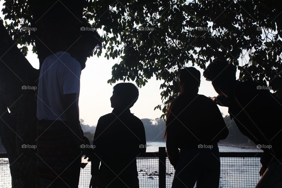 Cousins having fun together while watching the lake.