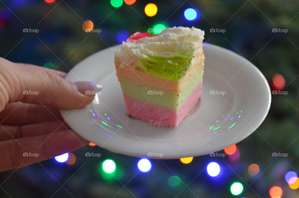 Women's hand holding slice of cake