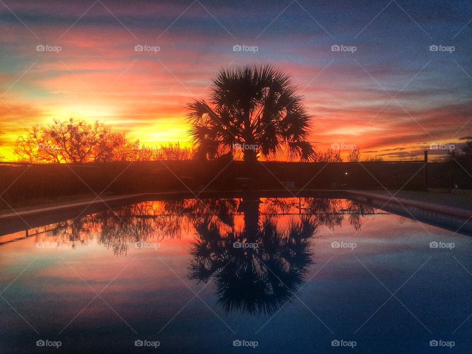 Sunset and pool with reflection 