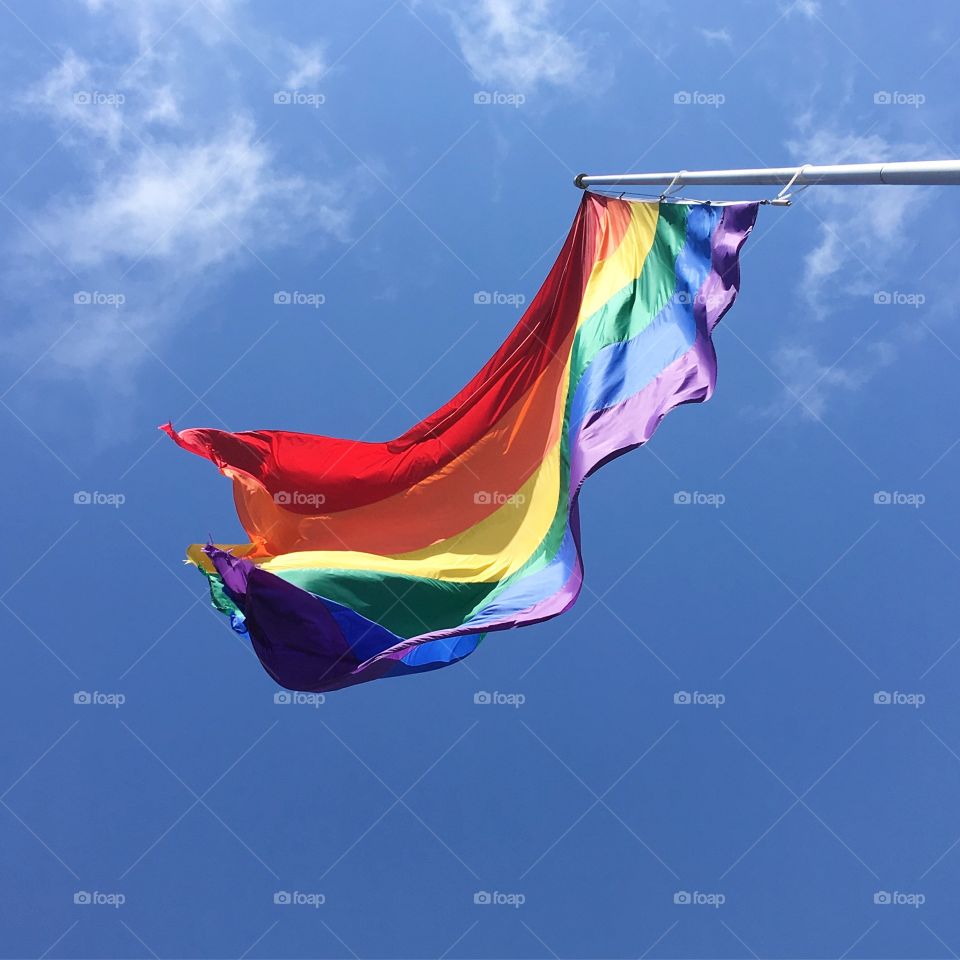 Gay pride flag billowing in the wind. 