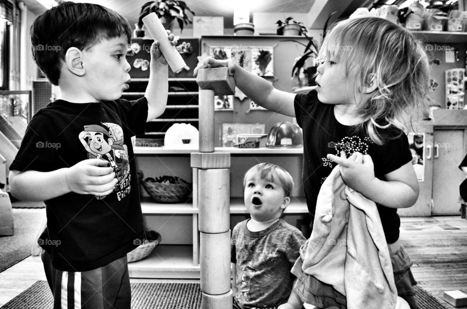 Children playing stacking wood blocks