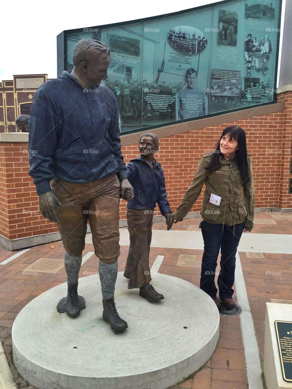 Woman holding the hand of statue