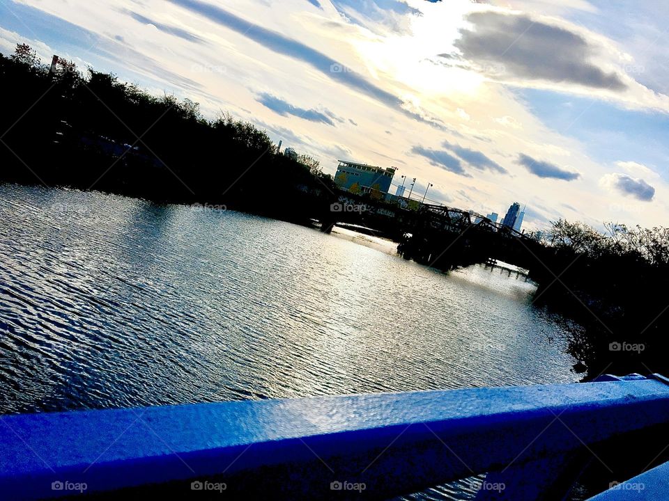 A panoramic view over the East River at Newtown Creek in Long Island City, Queens, NY seen from atop the Pulaski Bridge just around the time of upcoming twilight. 2021. Hypnotic Productions