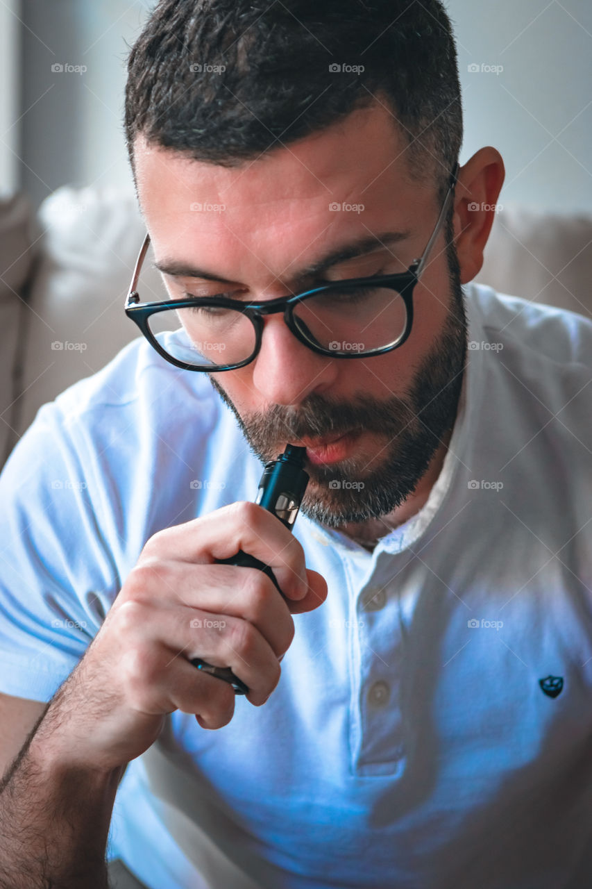 Man smoking while relaxed at home