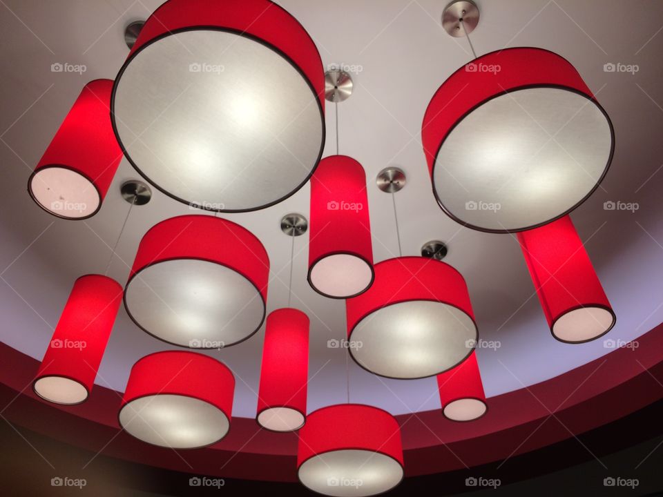 Red light or lamp shades hanging from a ceiling 