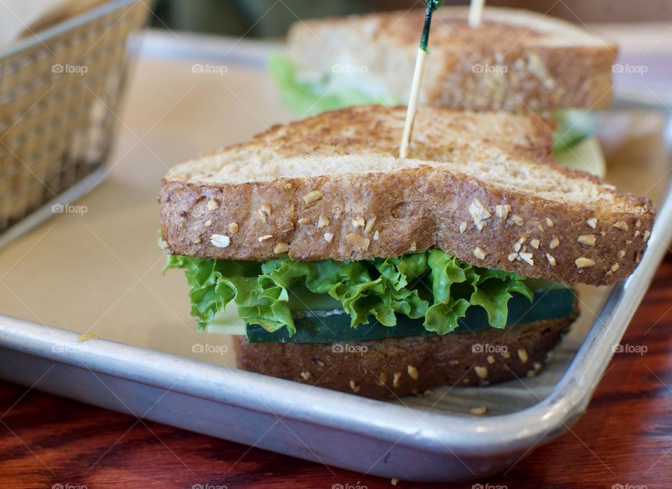 Veggie sandwich on oat bread on a plate 
