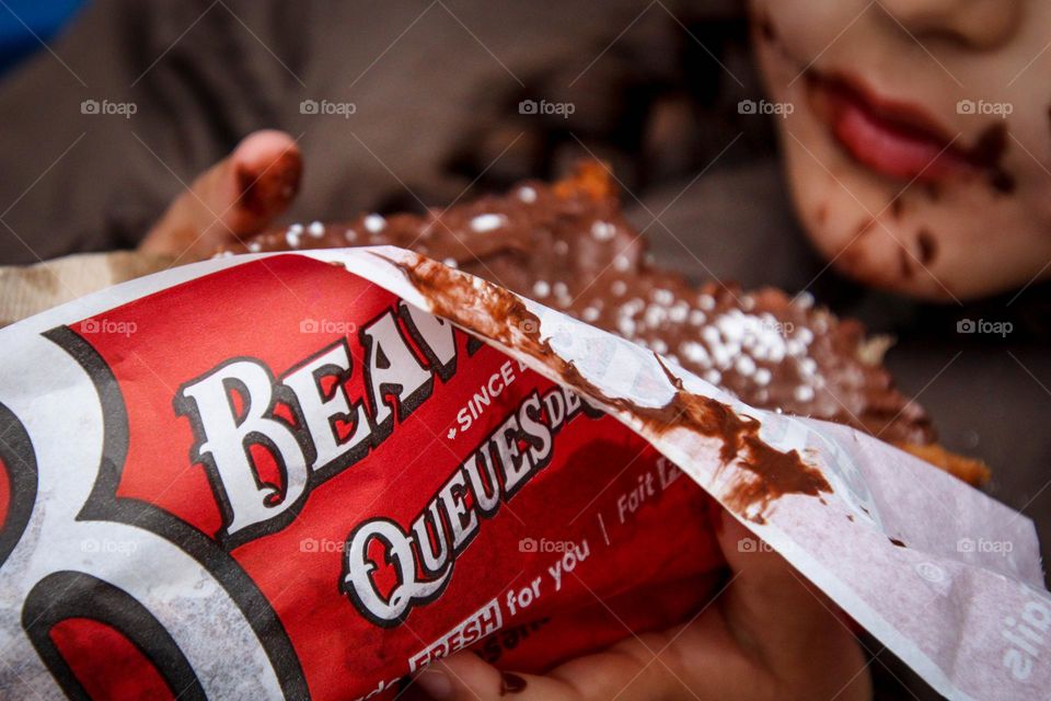 Child is holding beaver tail treat