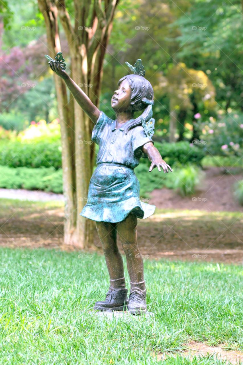 girl butterfly statue in the garden
