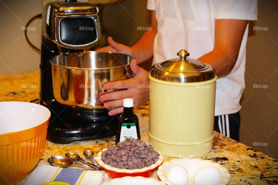 Mixing chocolate chip cookie dough with ingredients