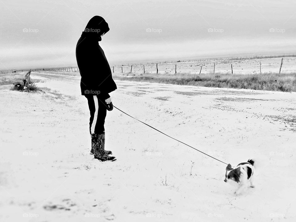 Man with his head down while Miserable Dog Walking on a Cold Isolated Road in the middle of nowhere & in the middle of winter. Looks lonely,  sad & cold. 😰🥶