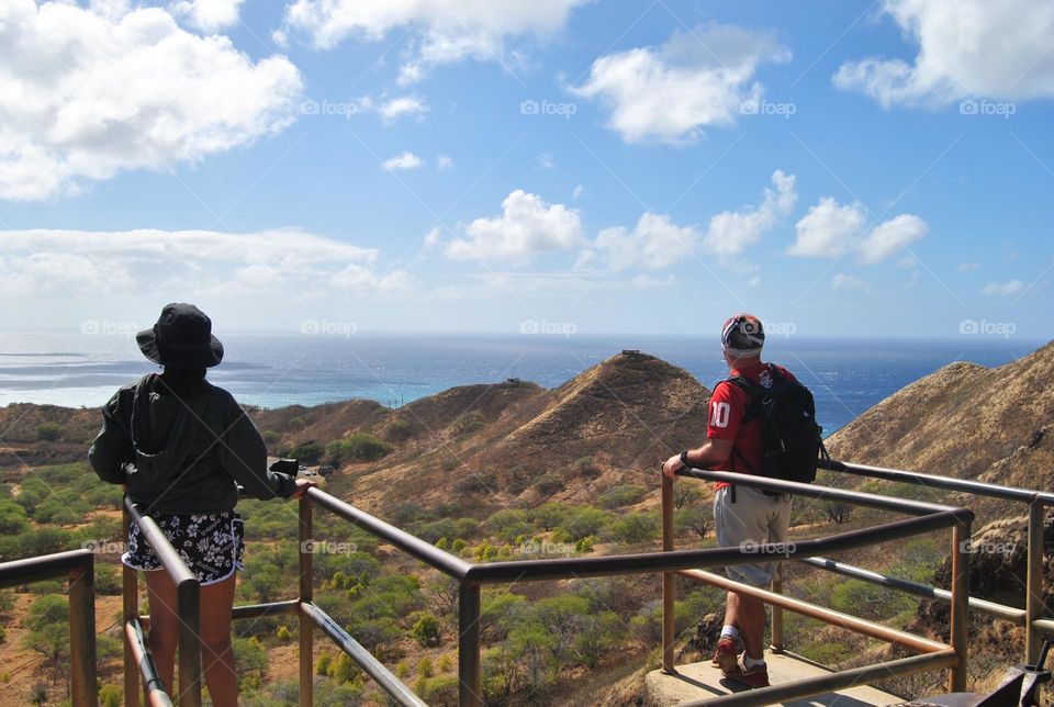 Couple looking from a view point from top a Diamond Head hiking trail 