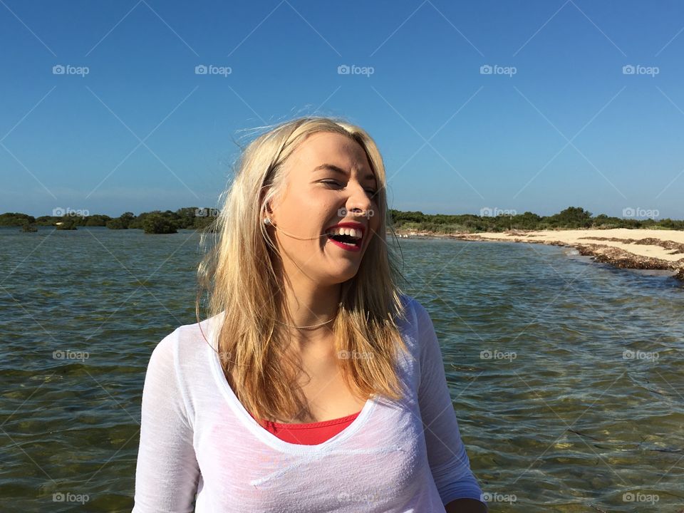 Close-up of happy young woman at sea side