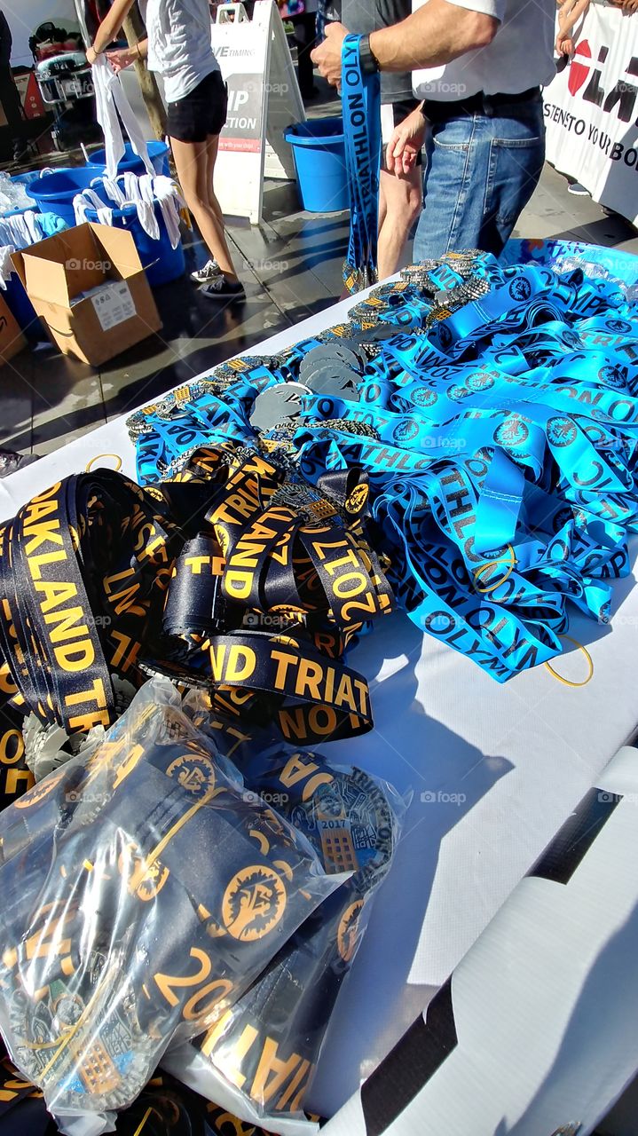 Table of medals at the finish line of the Oakland Triathalon.