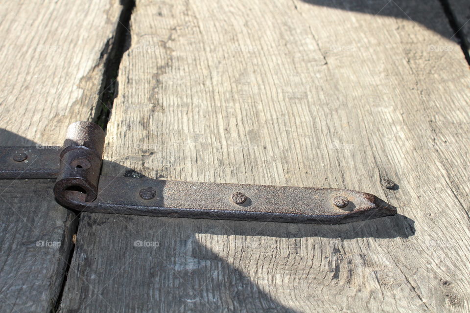 old door hinge with nails close-up