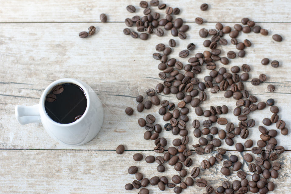 Coffee in a mug and coffee beans
