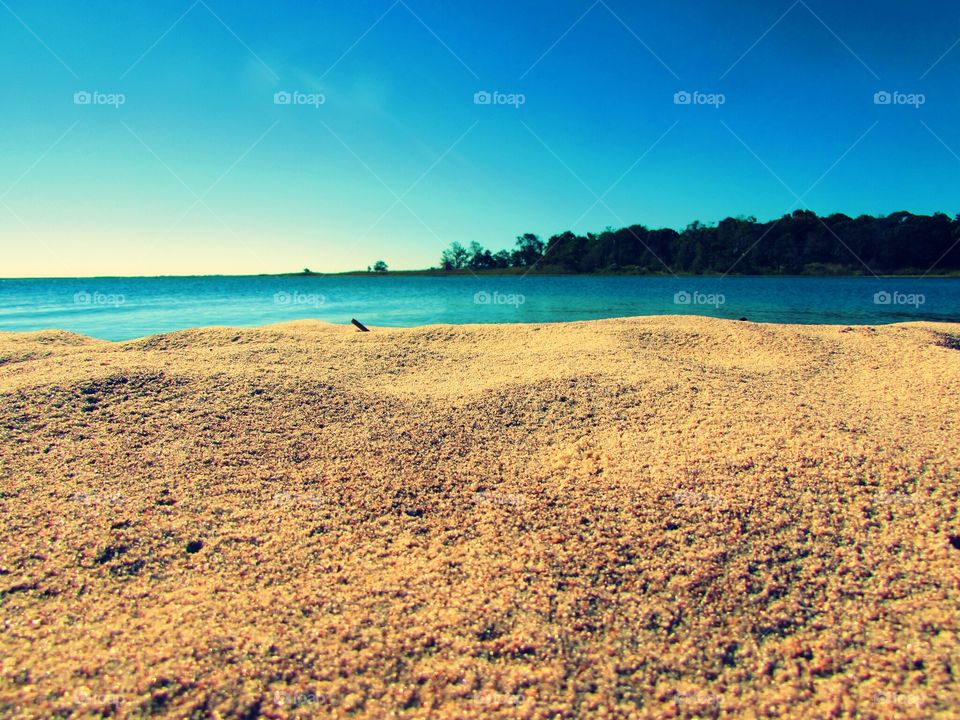 the beach. soft sand and blue waters.