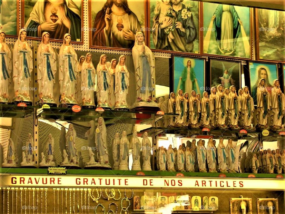 Souvenir statues and relics in the shops Lourdes, France 