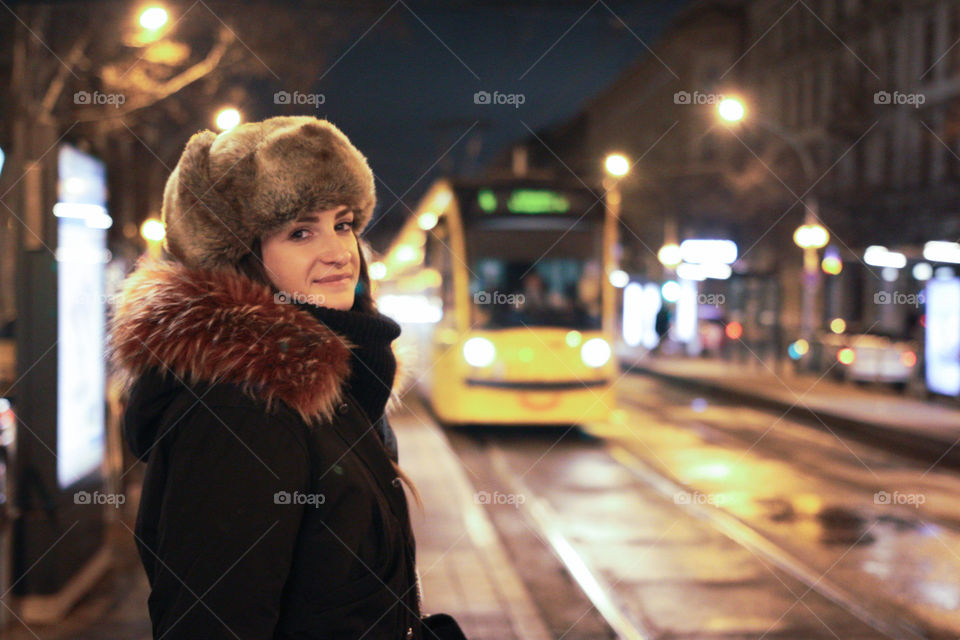 A girl tourist portrait with a blurred tram in the background