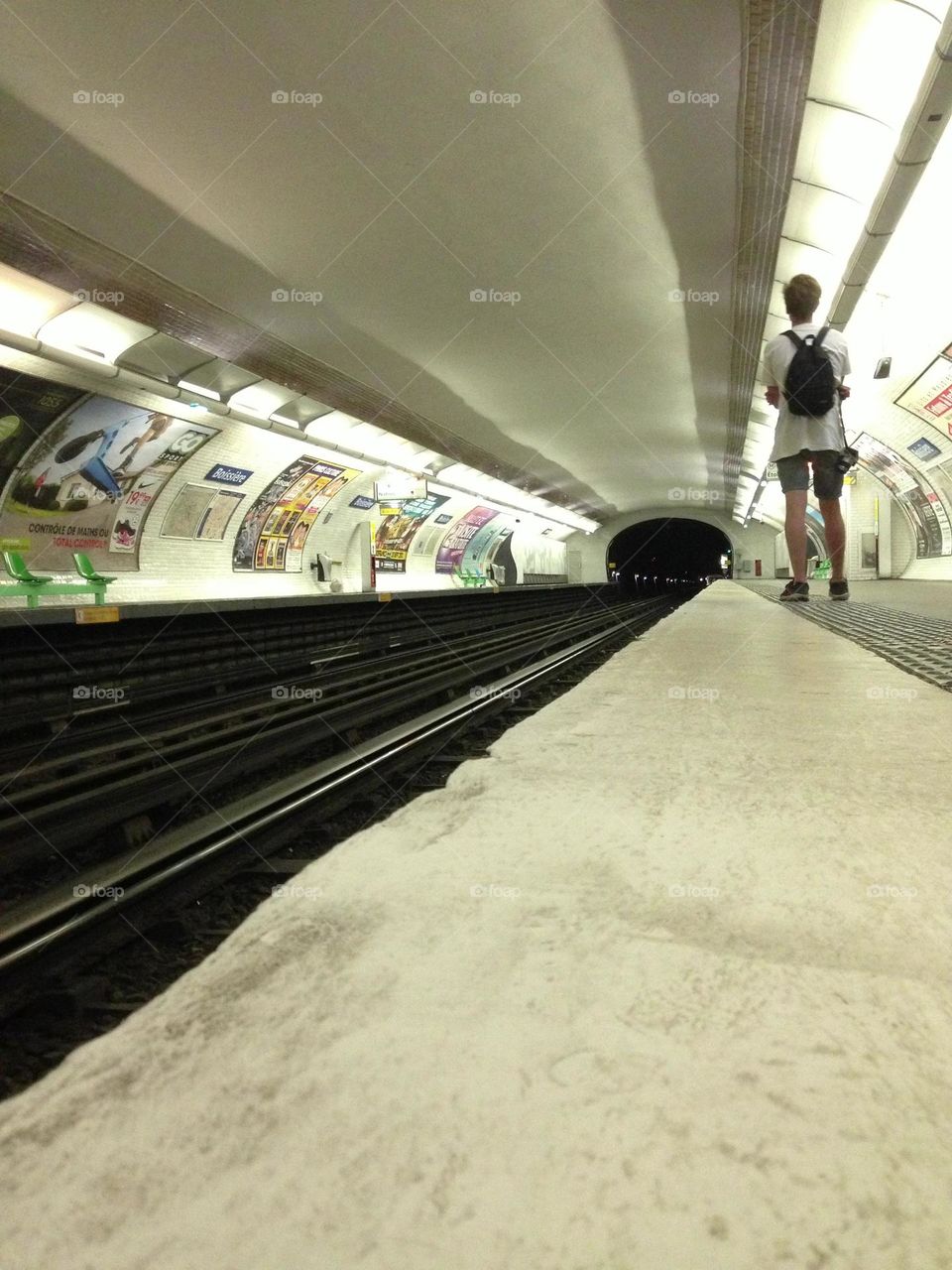 Tube train station with one passenger in the city