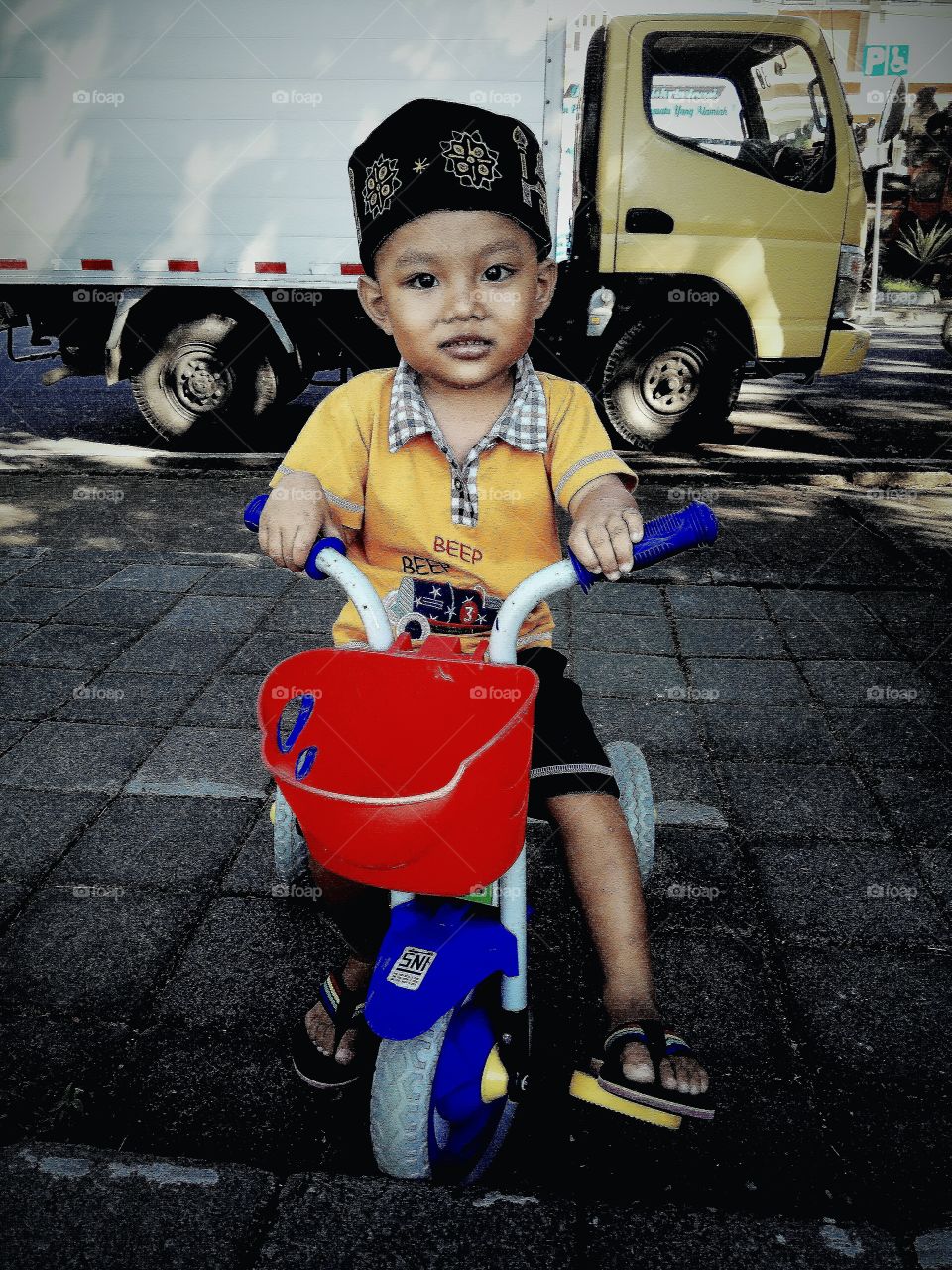 Cute boy riding bicycle on road