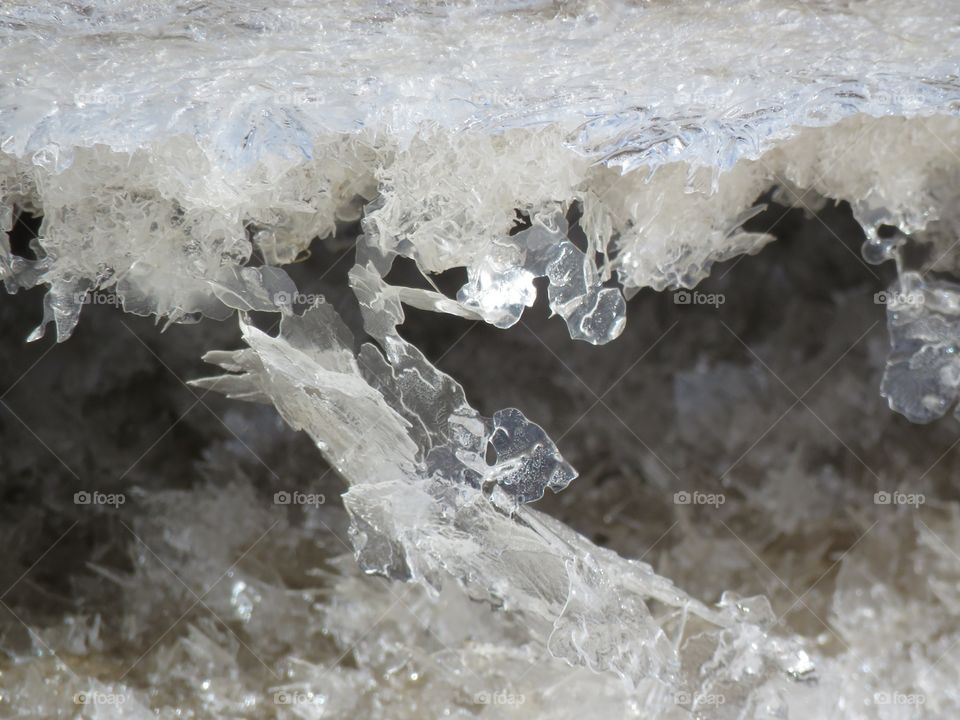 Close up of a snow bank made of icy, crystal-like snow. 