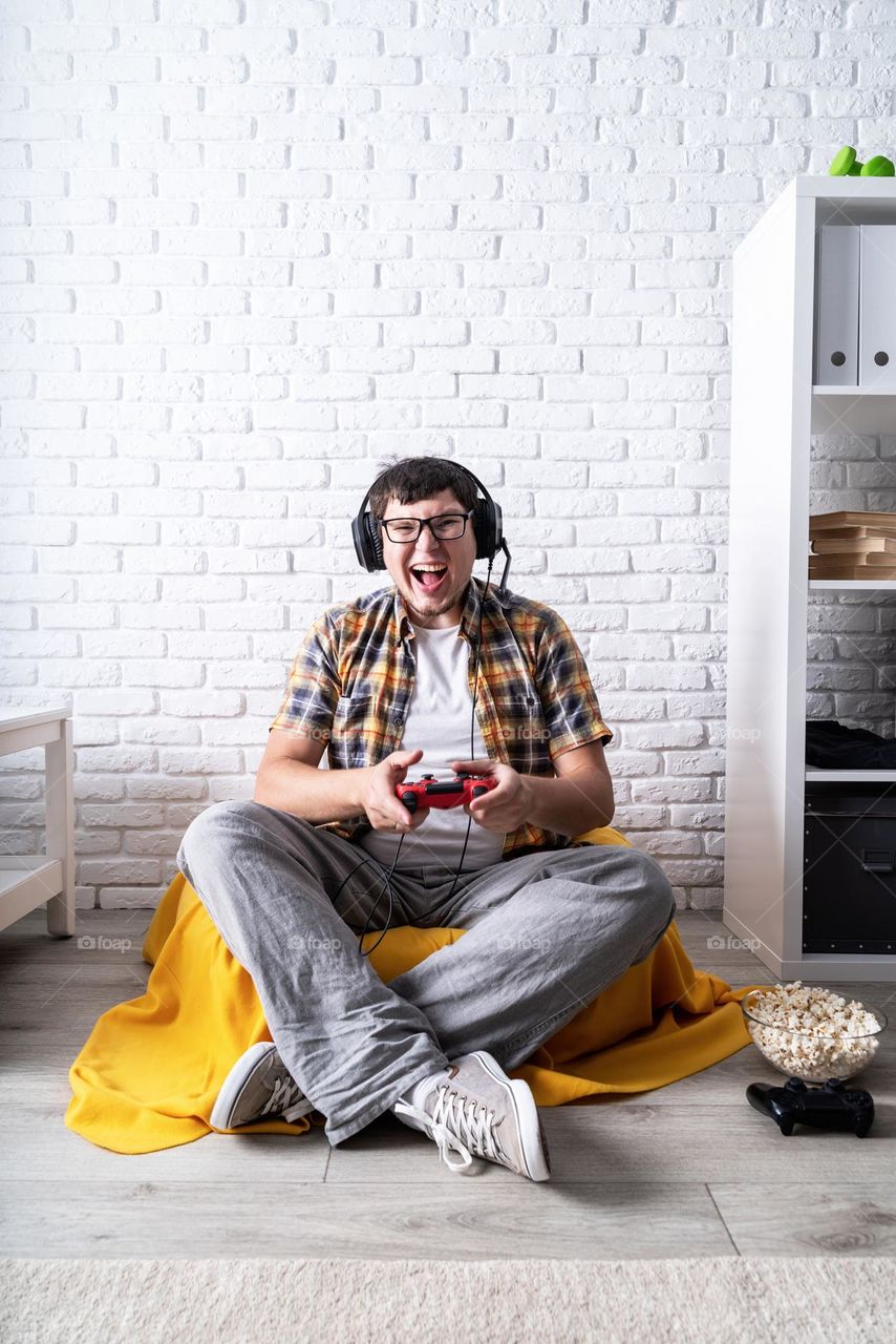 young emotional man playing video games