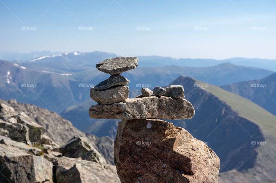 Stacking rocks on top of mountain.