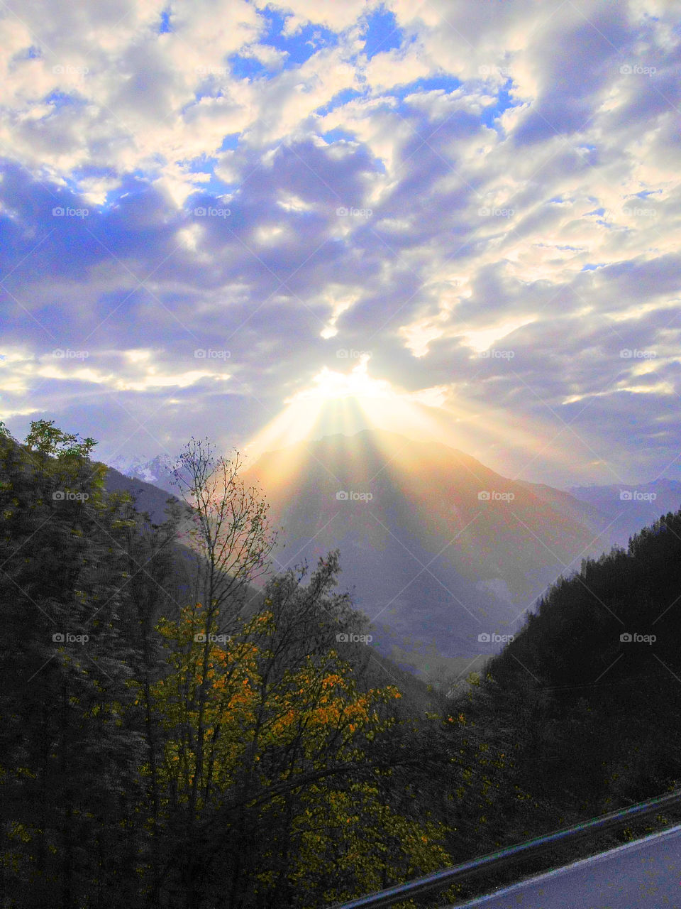 sunset through clouds by swisstraveler