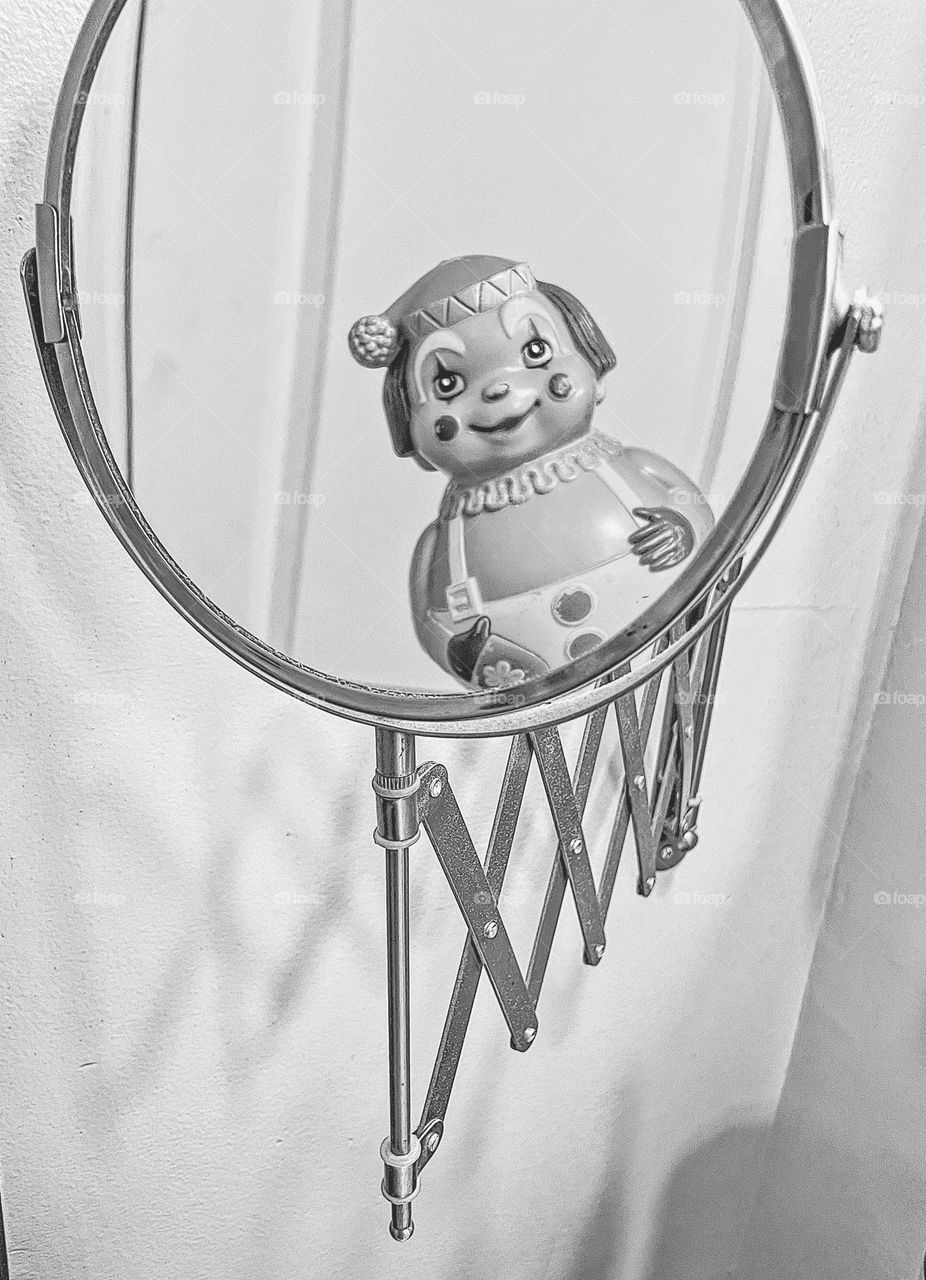 Clown reflection in mirror, not ordinary reflections in a mirror, black and white clown reflection, mirror reflecting clown image, monochrome clown portrait, unexpected mirror reflection 