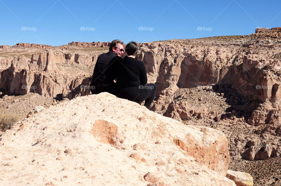 Couple talking at top of cliff