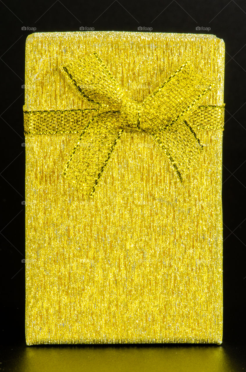 yellow gift box on black background.