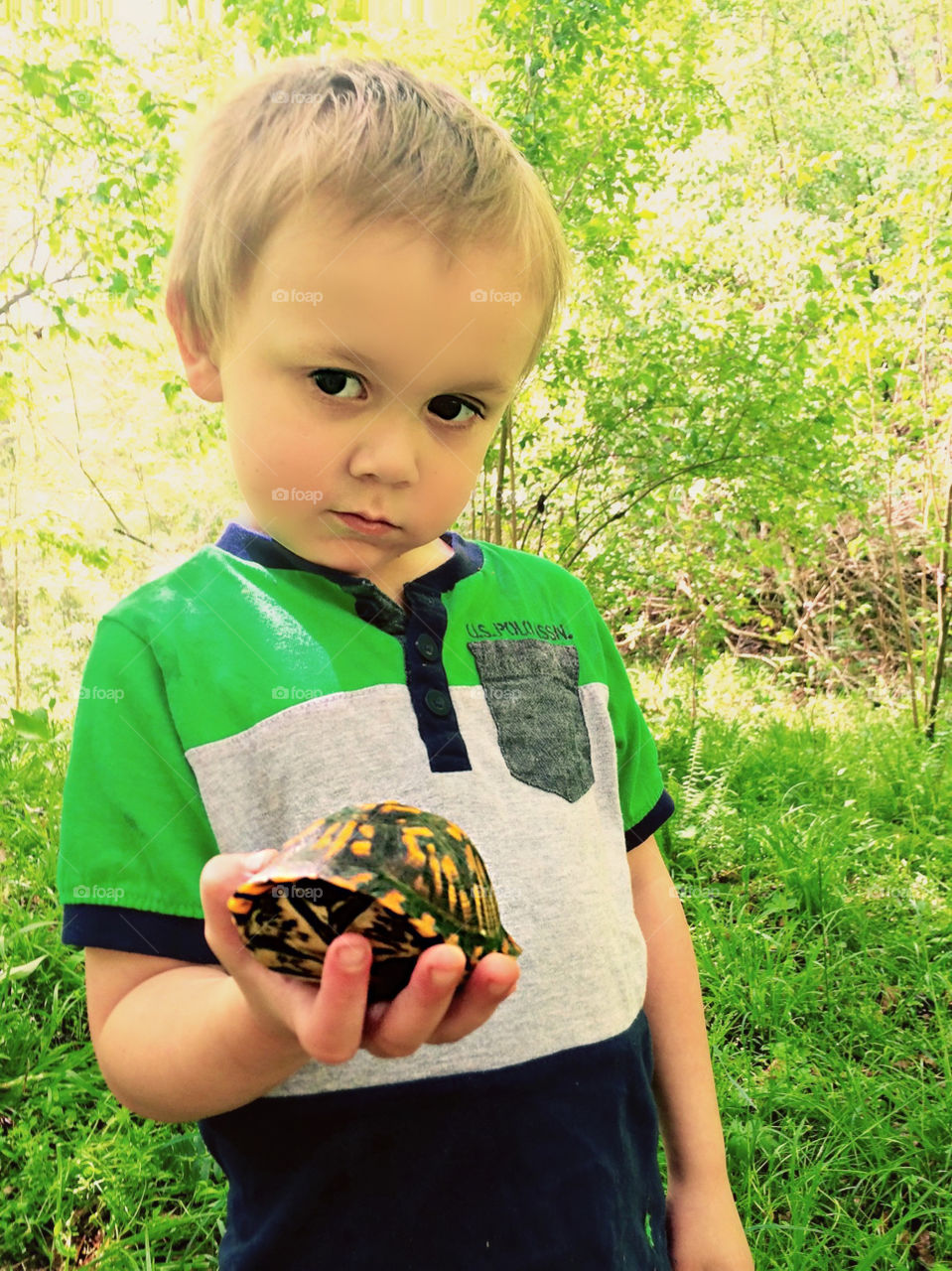 This Little Boy rescued and found a safer home for a cute scared turtle. 