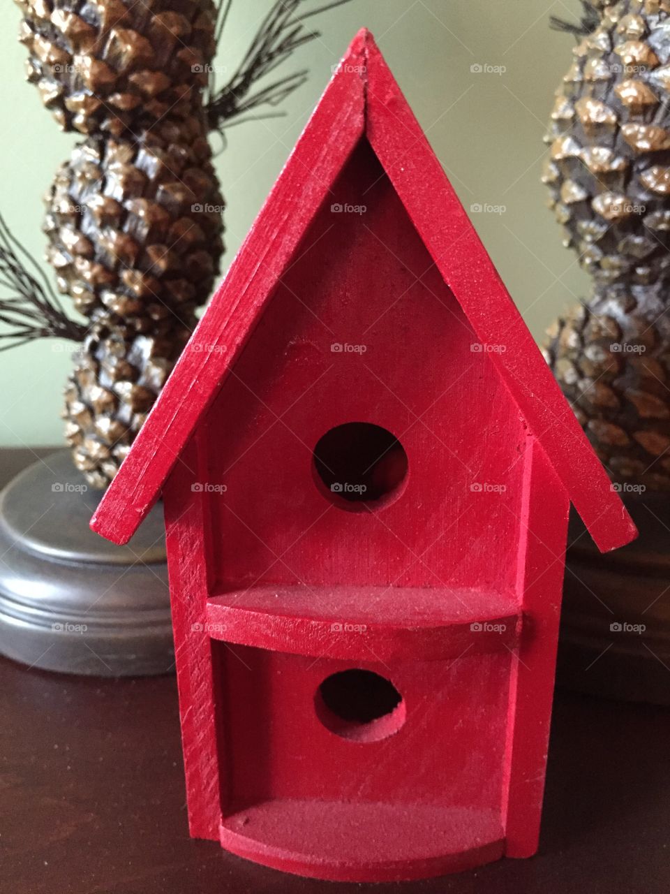 Small red wooden birdhouse 