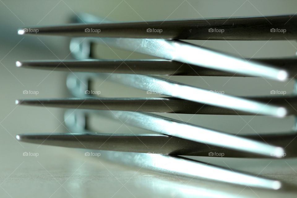 Close-up of two forks intertwined