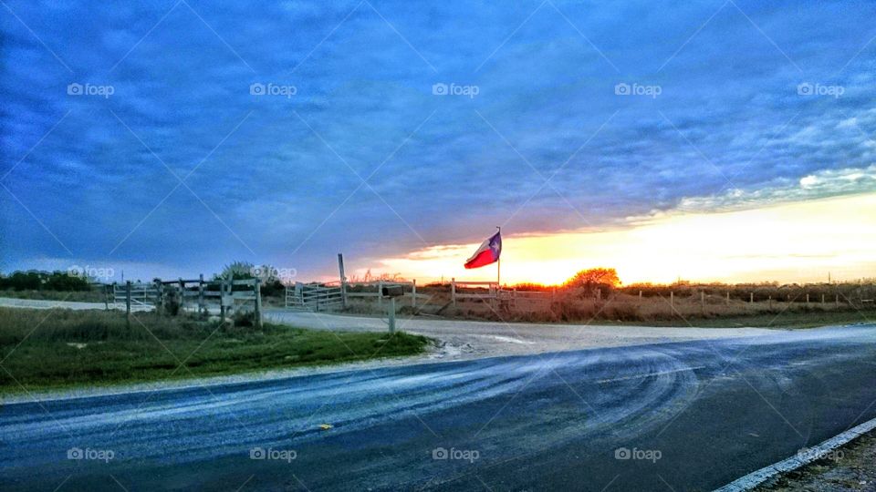 South Texas sky cloudy flag windy country road