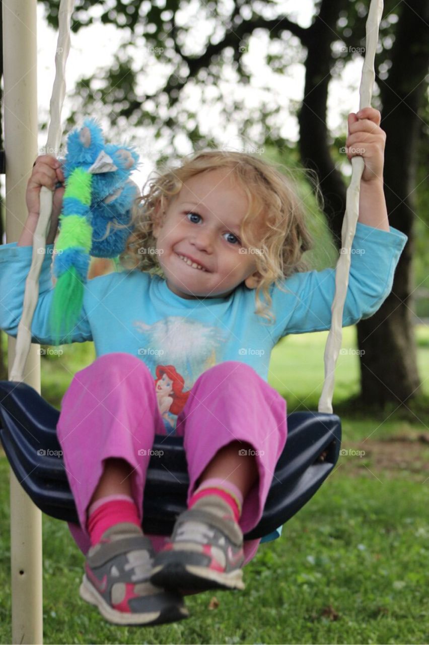 Girl enjoying on rope swing