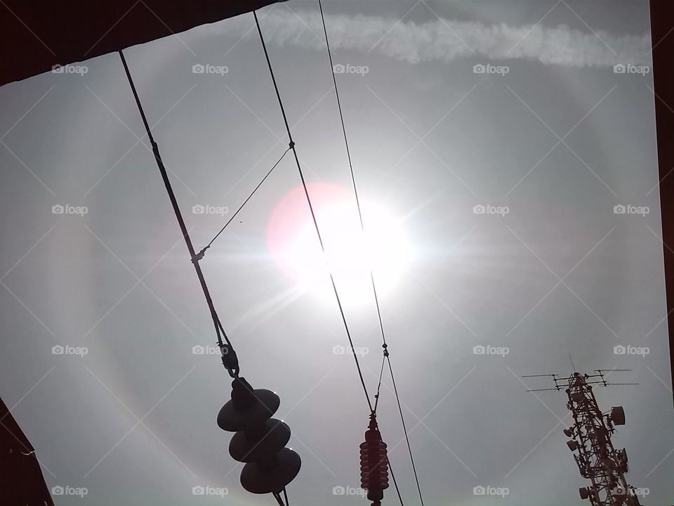 A circle with the sun above the train station.