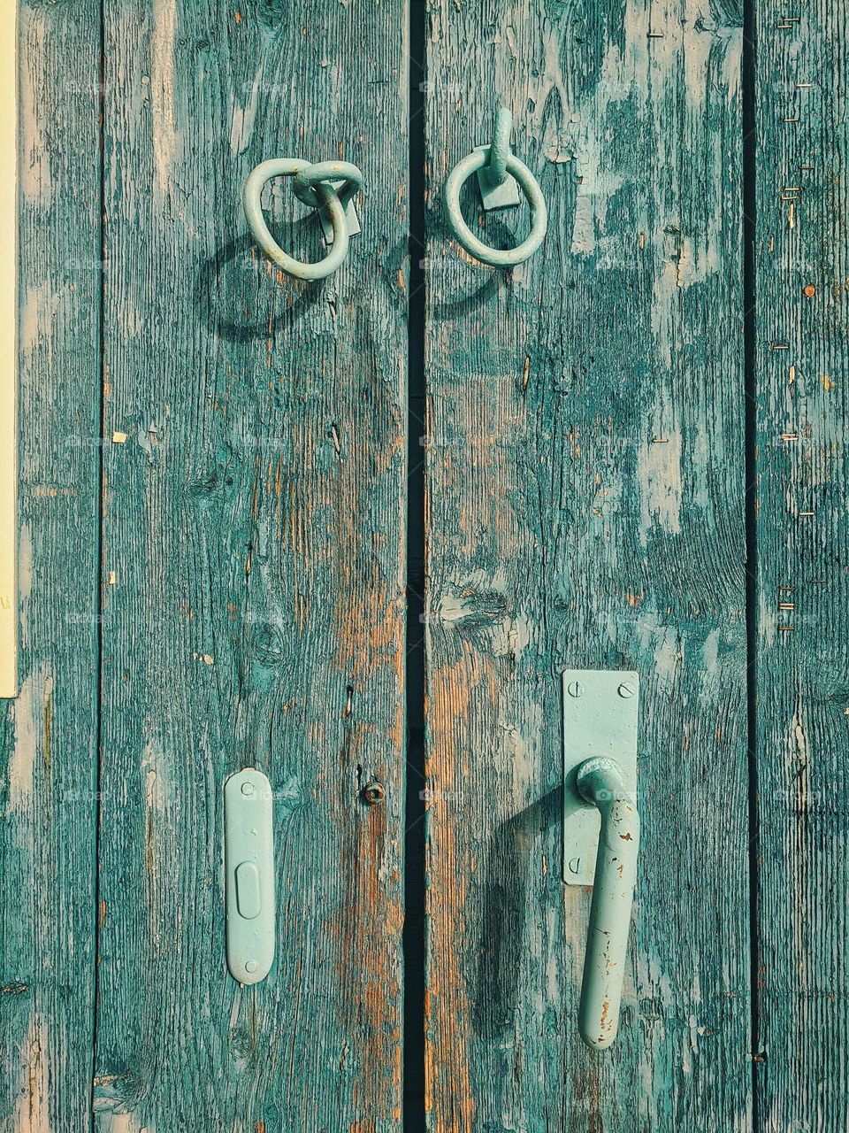 Antique wooden door in blue color with a lock in the seaport.