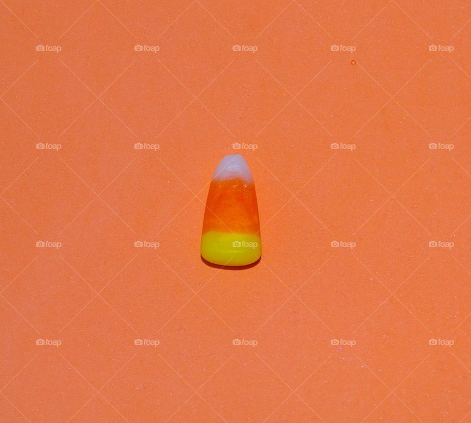 Candy corn on an orange background 