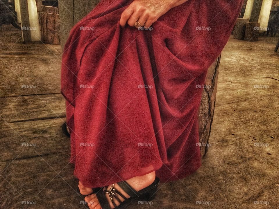 Red dress against a wooded background 
