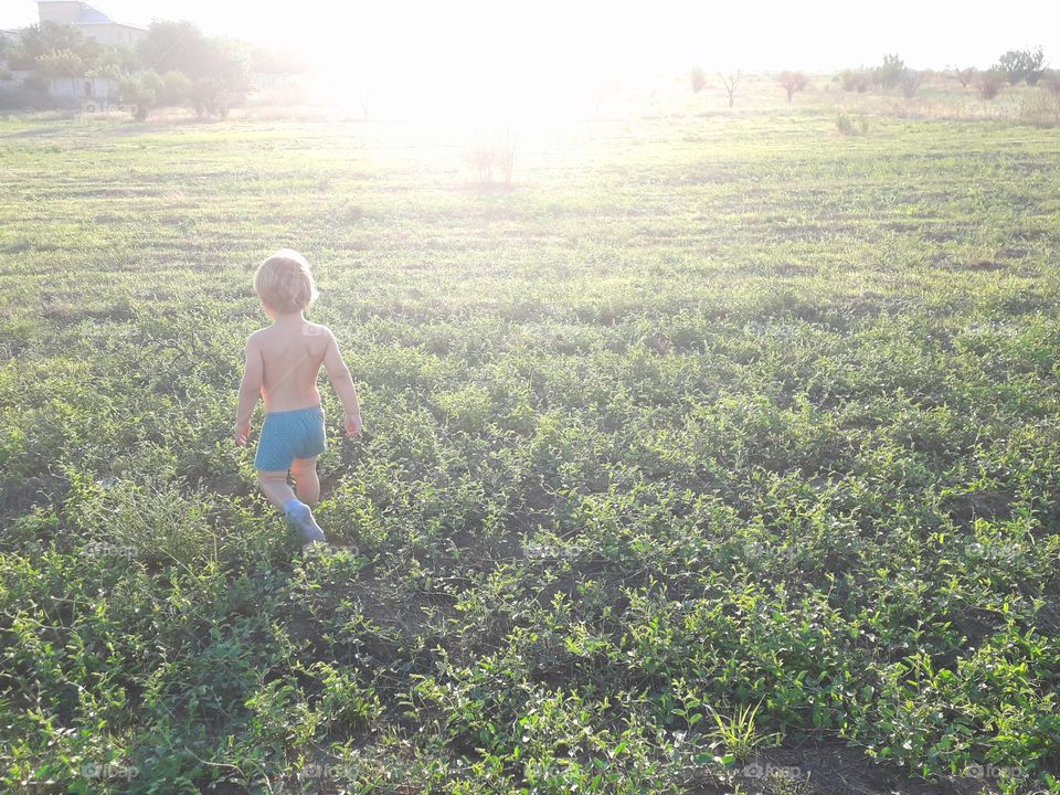 boy walking on the field