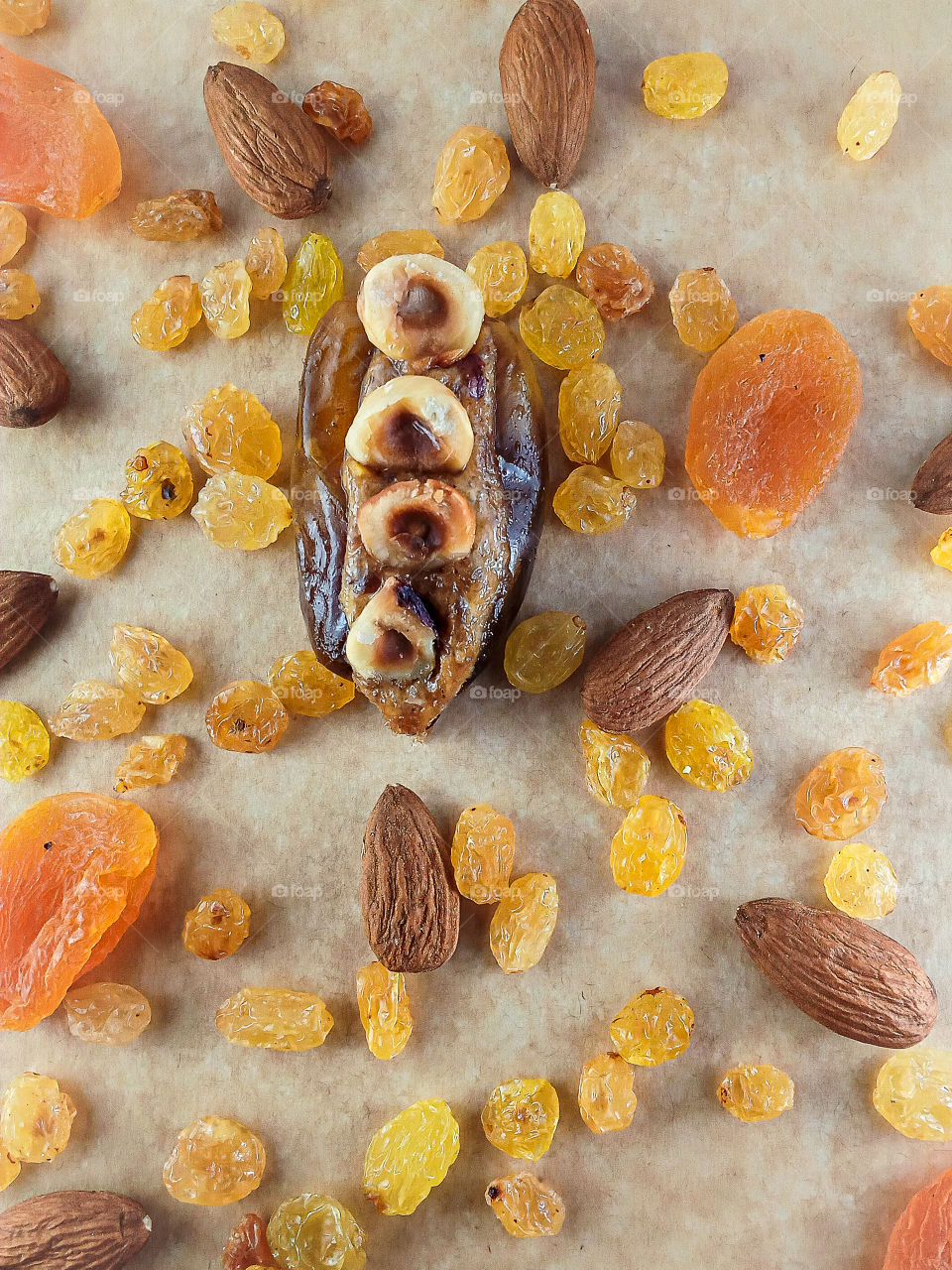 various dried fruits presented with a date stuffed with a halva