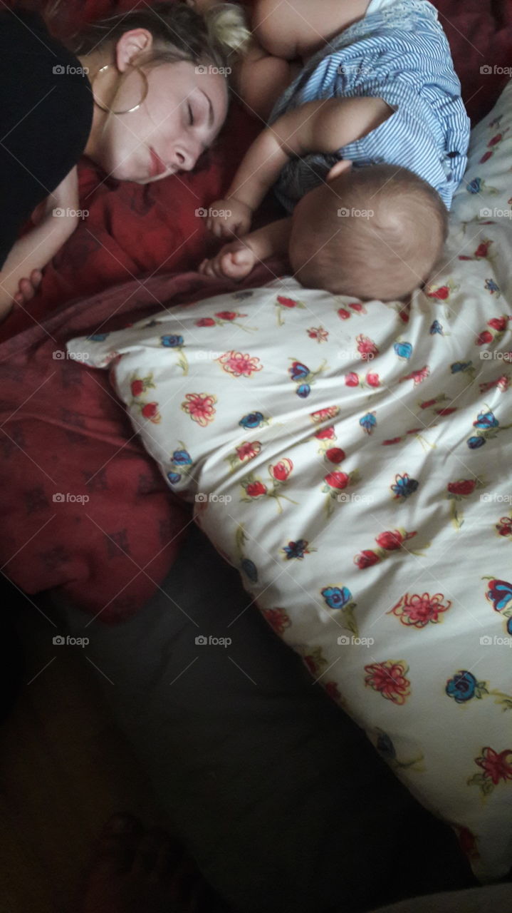 Mother and daughter sleeping on bed