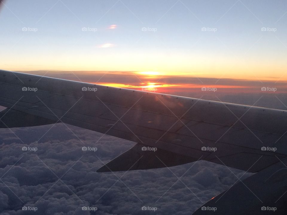 Sunset from the sky. Sunset over airplane wing