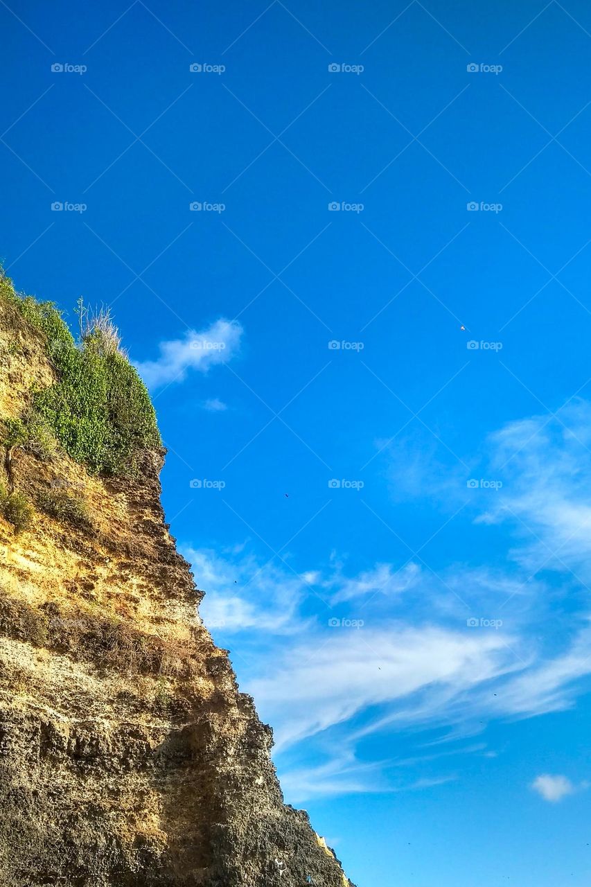 Cliffs with hot, cloudy weather in low angle view