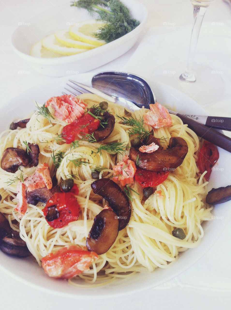 Salmon pasta with tomatoes, capers, mushrooms and dill.